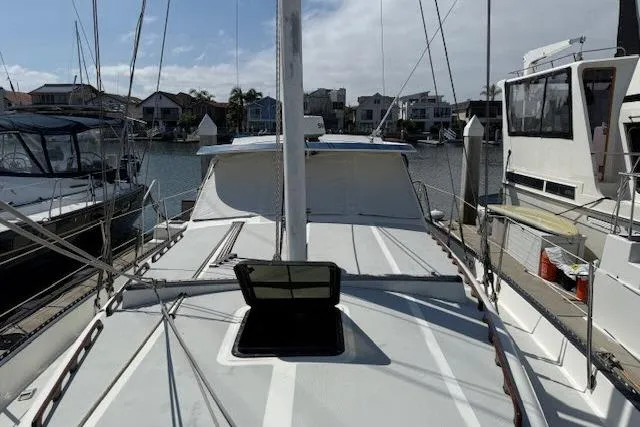 Slide: The Image of 1982 Lancer 45 Motorsailer docked in a marina, surrounded by other boats. - 37
