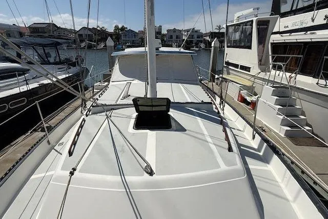 Slide: The Image of 1982 Lancer 45 Motorsailer docked at marina, showcasing deck and rigging. - 38