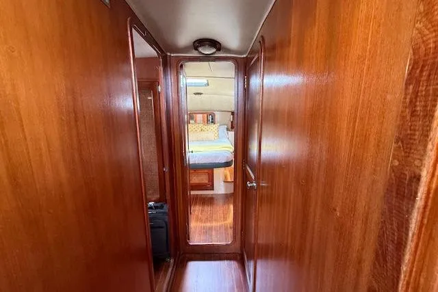 Slide: The Image of Interior hallway of 1982 Lancer 45 Motorsailer with wooden paneling and visible cabin. - 4