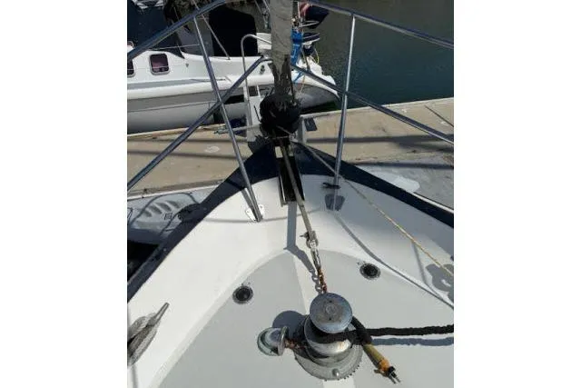 Slide: The Image of 1982 Lancer 45 Motorsailer bow with winch and railing at dock. - 40