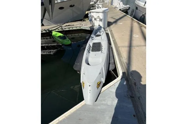 Slide: The Image of A 1982 Lancer 45 Motorsailer docked, with a small green kayak nearby. - 41
