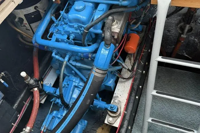 Slide: The Image of Engine compartment of a 1982 Lancer 45 Motorsailer, featuring a blue-painted engine. - 44