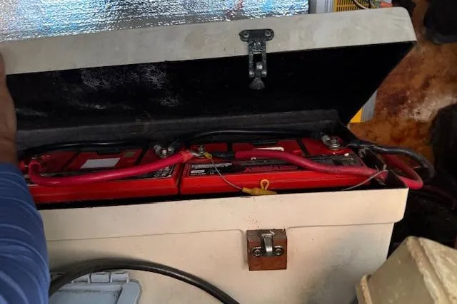 Slide: The Image of Battery compartment of a 1982 Lancer 45 Motorsailer with red cables and secure latch. - 47