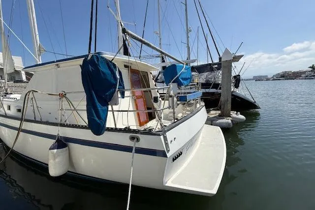 Slide: The Image of 1982 Lancer 45 Motorsailer docked at marina, clear sky, calm water. - 49