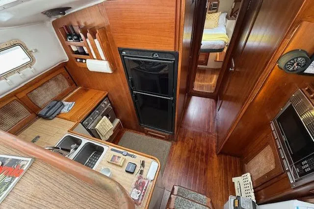 Slide: The Image of Interior of 1982 Lancer 45 Motorsailer with wood finish, kitchen, and cozy cabin. - 5