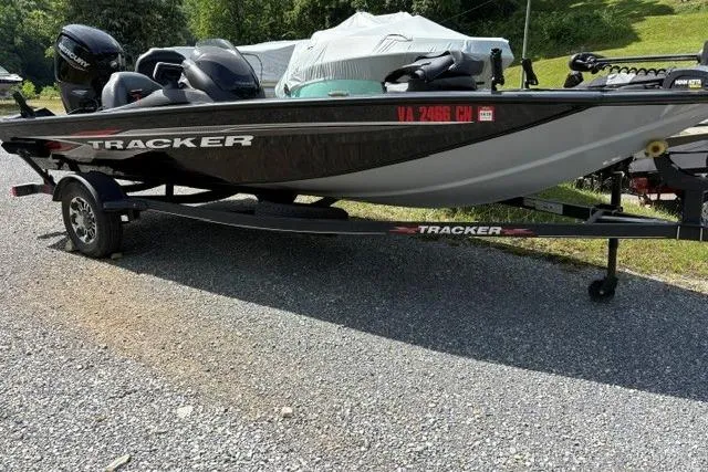 The Image of 2023 Tracker Pro Team 175 TXW boat on trailer, parked outdoors. - 1