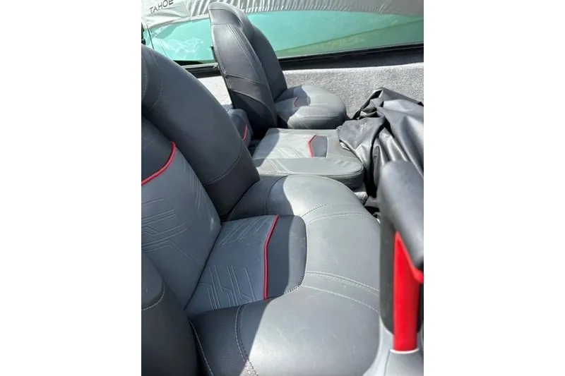 Slide: The Image of 2023 Tracker Pro Team 175 TXW boat seats with gray upholstery and red accents. - 11