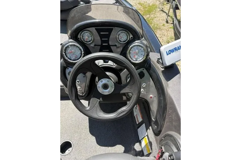 Slide: The Image of 2023 Tracker Pro Team 175 TXW boat dashboard with steering wheel and gauges. - 5