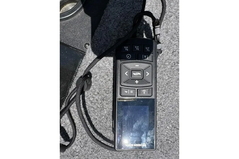 Slide: The Image of Remote control on a 2023 Tracker Pro Team 175 TXW boat deck. - 6