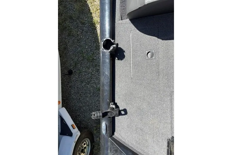 Slide: The Image of 2023 Tracker Pro Team 175 TXW boat deck with rod holder and carpeted surface. - 9
