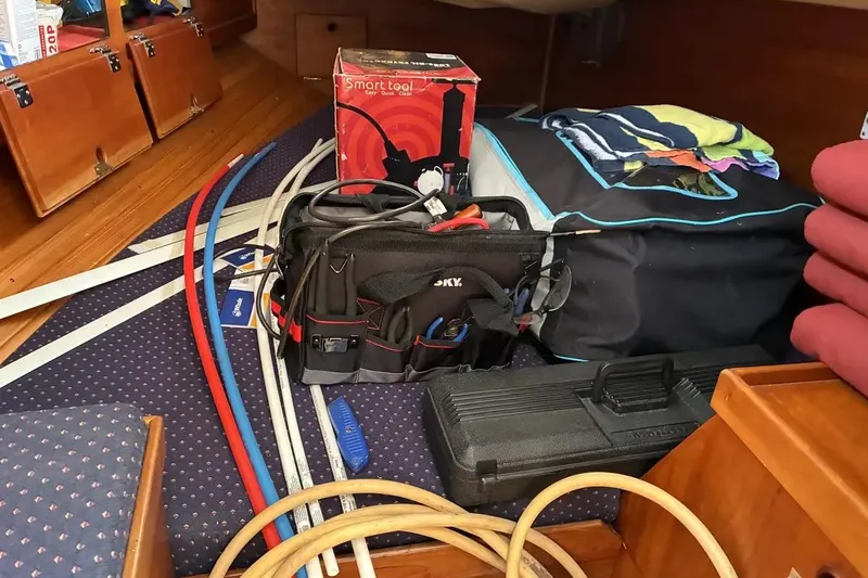 Slide: The Image of Interior of a 1998 Sabre 36 sailboat with tools and equipment organized. - 13