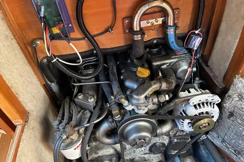 Slide: The Image of Engine compartment of a 1998 Sabre 36 sailboat, featuring mechanical components and wiring. - 18