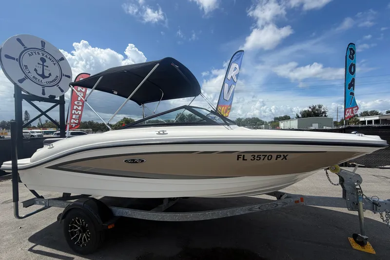 The Image of 2015 Sea Ray 19 SPX boat on trailer, displayed outdoors under a clear sky. - 0