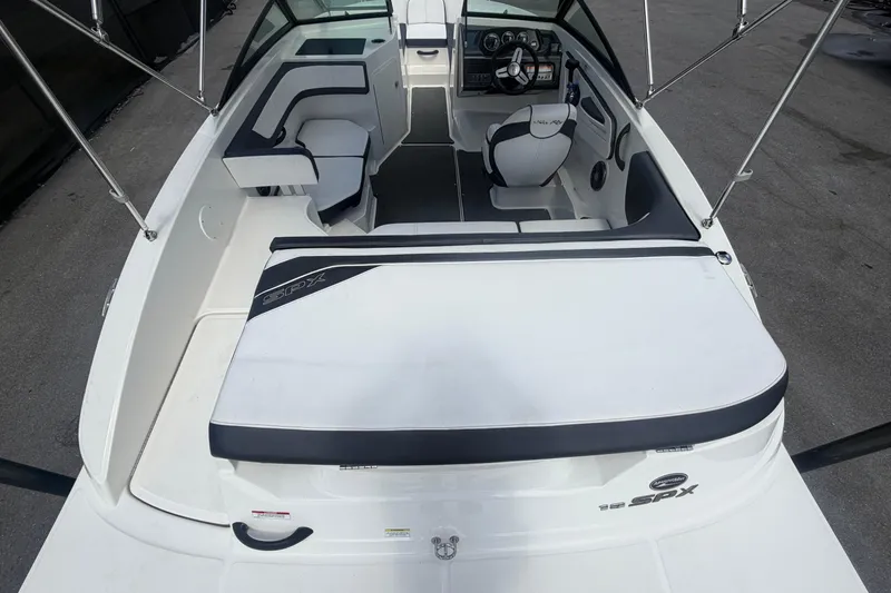 Slide: The Image of 2015 Sea Ray 19 SPX boat interior with seating and steering wheel. - 12