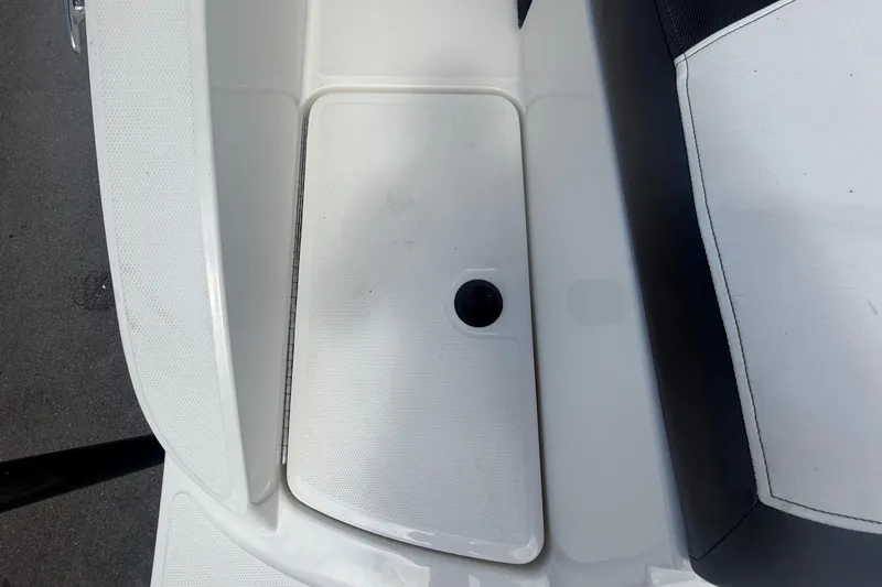 Slide: The Image of 2015 Sea Ray 19 SPX boat interior detail, featuring white and black seating. - 13