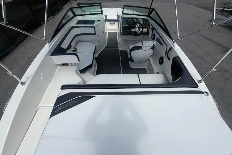 Slide: The Image of 2015 Sea Ray 19 SPX boat interior with seating and steering console. - 15