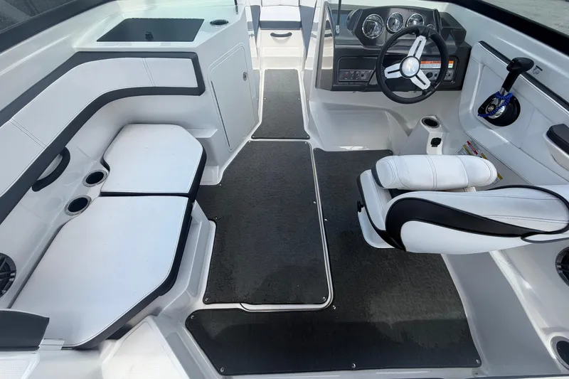 Slide: The Image of Interior of a 2015 Sea Ray 19 SPX boat with seating and steering wheel. - 17