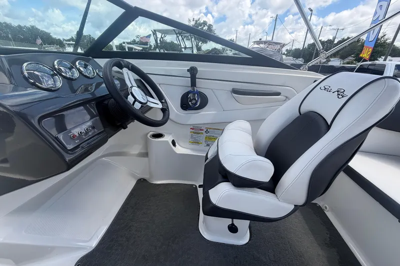 Slide: The Image of 2015 Sea Ray 19 SPX boat interior with steering wheel and captain's chair. - 18