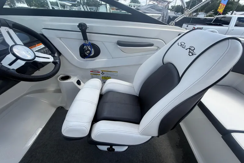 Slide: The Image of Interior of 2015 Sea Ray 19 SPX boat with steering wheel and branded seat. - 19