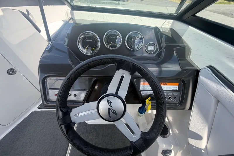 Slide: The Image of 2015 Sea Ray 19 SPX dashboard with steering wheel and instrument panel. - 20