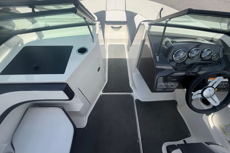 Slide: The Image of 2015 Sea Ray 19 SPX boat interior with steering wheel and dashboard gauges. - 26