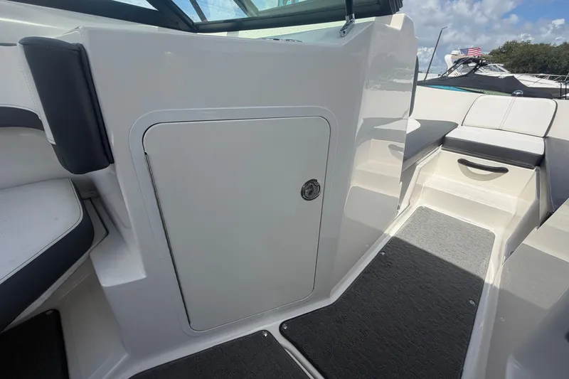 Slide: The Image of 2015 Sea Ray 19 SPX boat interior with seating and storage compartment. - 27