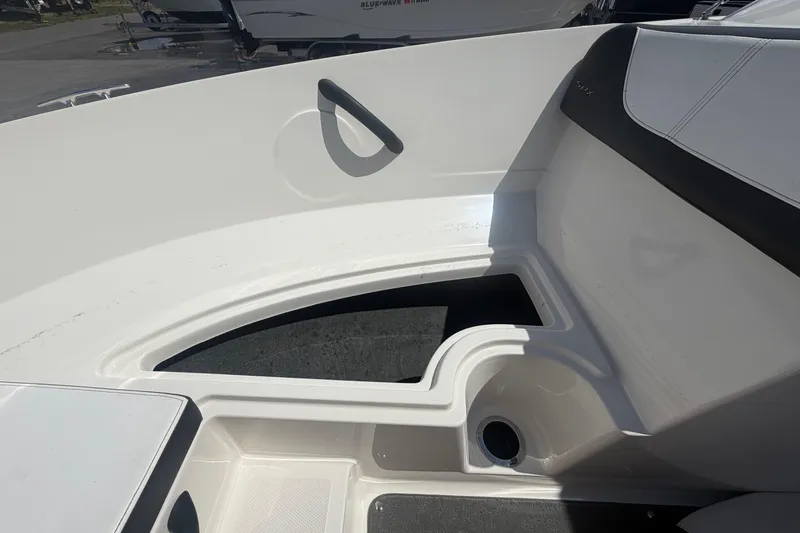 Slide: The Image of Interior view of a 2015 Sea Ray 19 SPX boat, showcasing seating and storage area. - 32