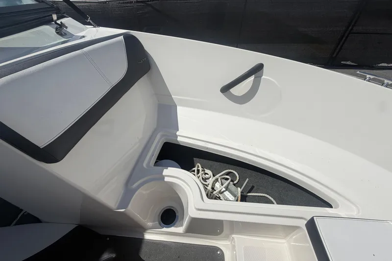 Slide: The Image of 2015 Sea Ray 19 SPX boat interior with storage compartment and rope. - 35