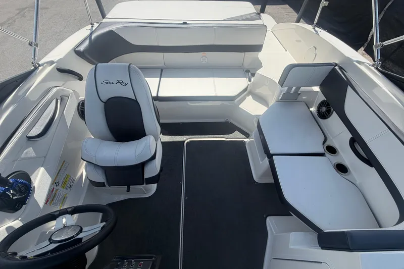 Slide: The Image of Interior of a 2015 Sea Ray 19 SPX boat with seating and steering wheel. - 40