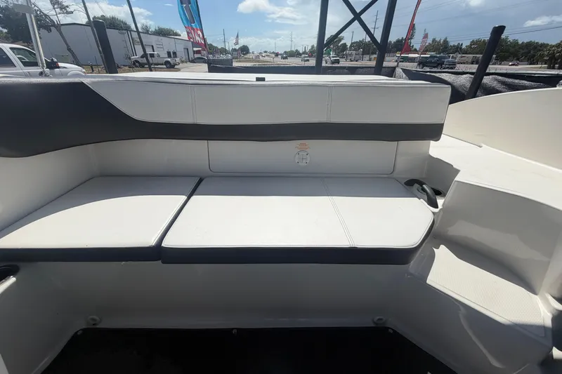 Slide: The Image of Interior seating of a 2015 Sea Ray 19 SPX boat, featuring white and black upholstery. - 46
