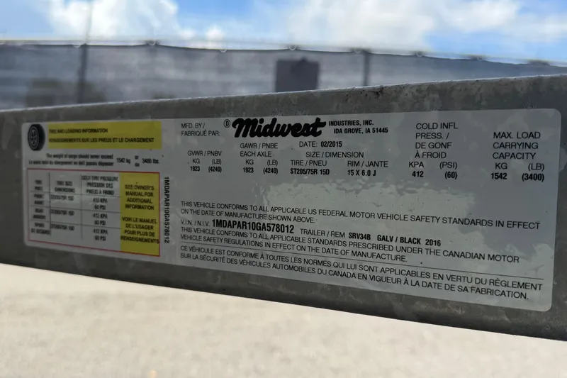 Slide: The Image of Label on Midwest trailer, detailing tire and load information, manufactured February 2015. - 55