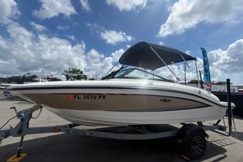 Slide: The Image of 2015 Sea Ray 19 SPX boat on trailer under a cloudy sky. - 8