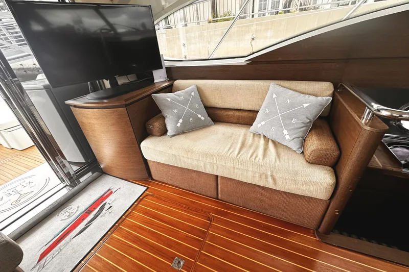 Slide: The Image of Luxurious interior of 2007 Azimut 43S yacht with cozy sofa and modern TV setup. - 11