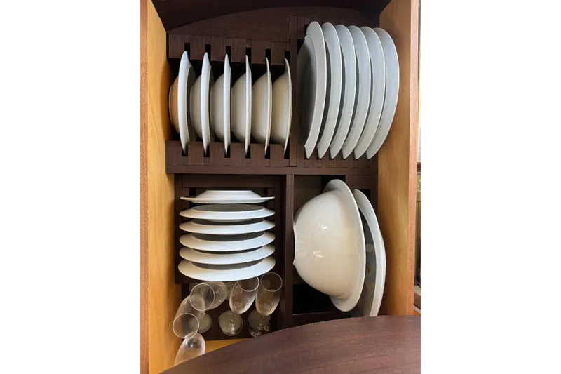 Slide: The Image of Cabinet with neatly organized white dishes and glasses on an Azimut 43S yacht. - 27