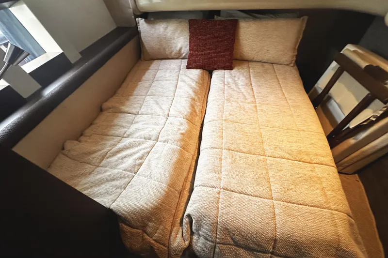 Slide: The Image of Interior of 2007 Azimut 43S yacht featuring a cozy twin bed setup. - 34
