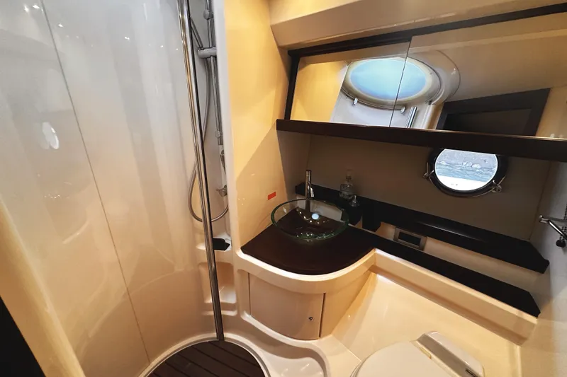 Slide: The Image of Luxurious bathroom in 2007 Azimut 43S yacht with modern fixtures and porthole window. - 35