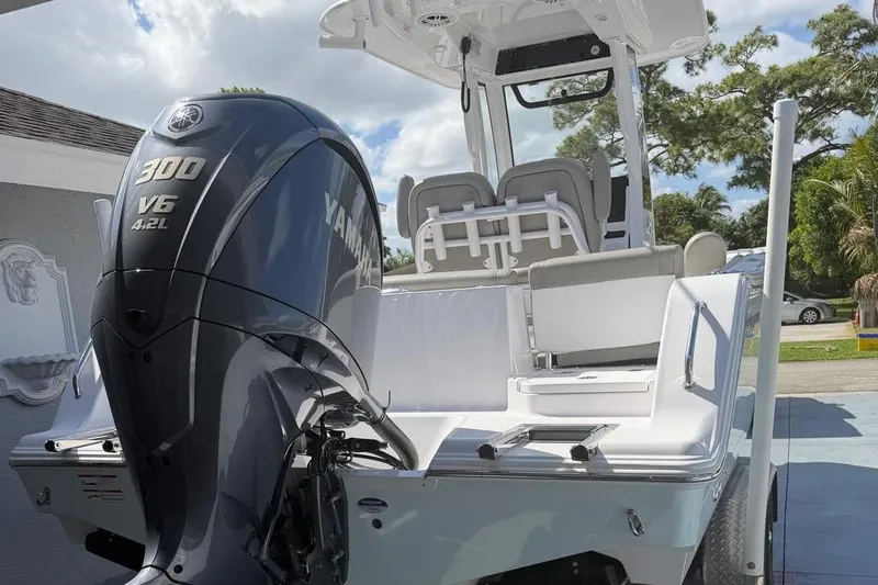 Slide: The Image of 2024 Sportsman Heritage 231 Center Console with Yamaha 300 V6 engine, parked outdoors. - 3