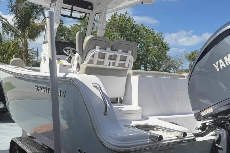Slide: The Image of 2024 Sportsman Heritage 231 Center Console boat with Yamaha engine, parked outdoors. - 4