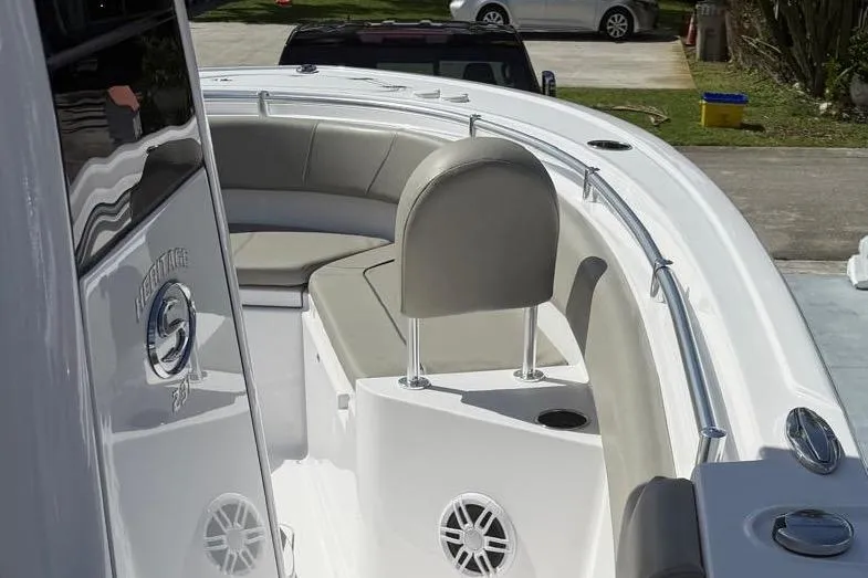 Slide: The Image of 2024 Sportsman Heritage 231 Center Console boat interior with cushioned seating and sleek design. - 8