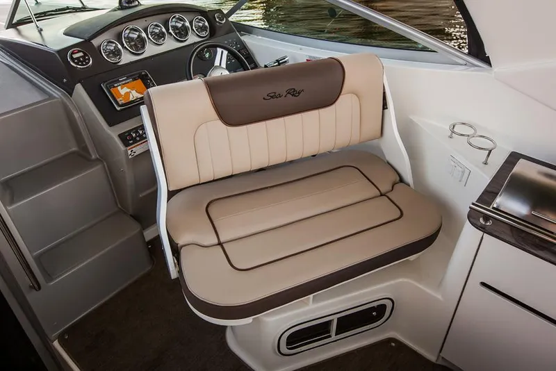 Slide: The Image of Manufacturer Provided Image: Captain's seat of a 2016 Sea Ray 310 Sundancer boat with dashboard and controls. - 5