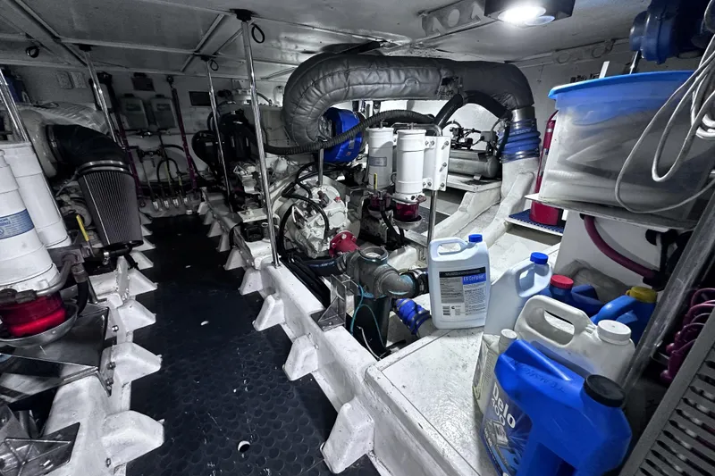 Slide: The Image of Engine room of a 2004 McKinna 57 PHMY Widebody yacht, featuring various mechanical components. - 107