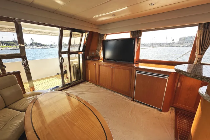 Slide: The Image of Luxurious 2004 McKinna 57 yacht interior with TV, seating, and ocean view. - 34