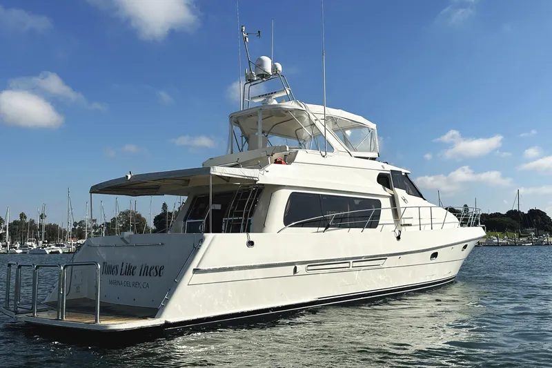 Slide: The Image of 2004 McKinna 57 PHMY Widebody yacht with stabilization, docked in a marina under blue skies. - 6