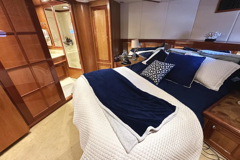 Slide: The Image of Luxurious bedroom interior of 2004 McKinna 57 PHMY yacht with elegant bedding and wood finishes. - 76