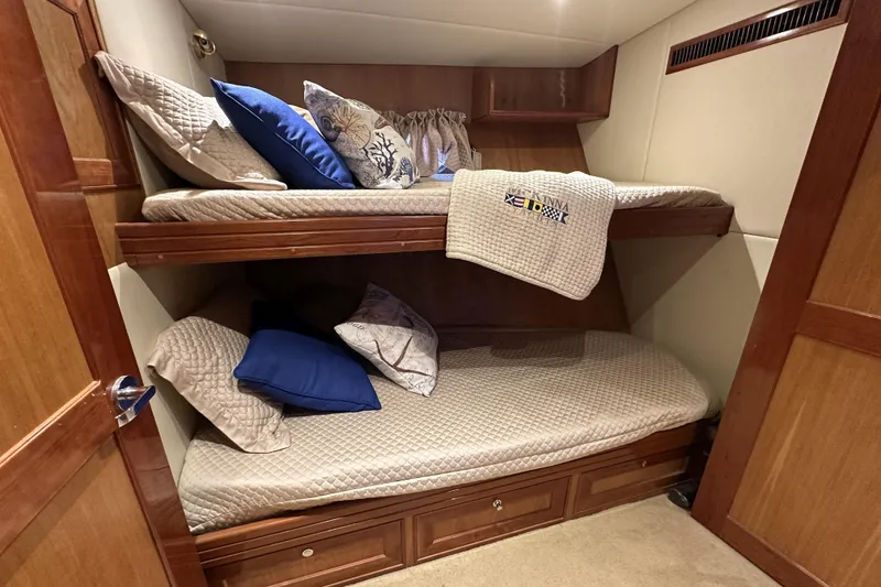 Slide: The Image of Bunk beds in 2004 McKinna 57 PHMY yacht cabin with cozy pillows and blankets. - 81