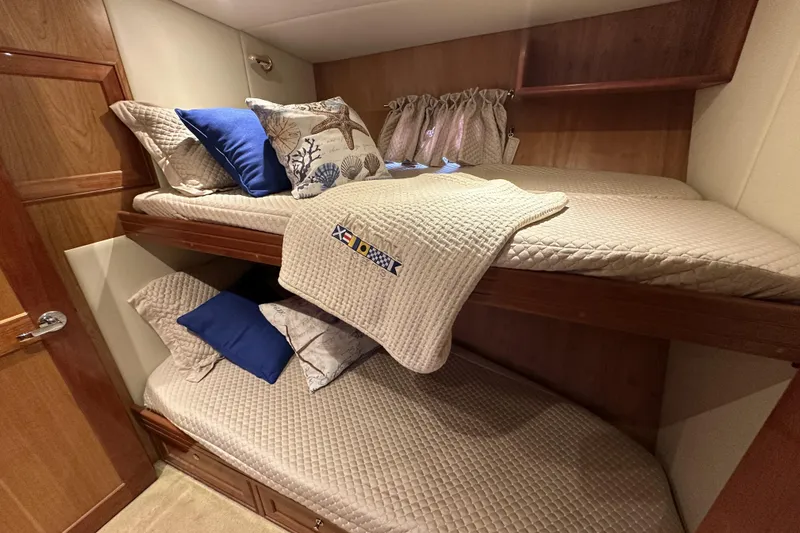 Slide: The Image of Bunk beds in 2004 McKinna 57 PHMY yacht cabin with nautical-themed pillows. - 83