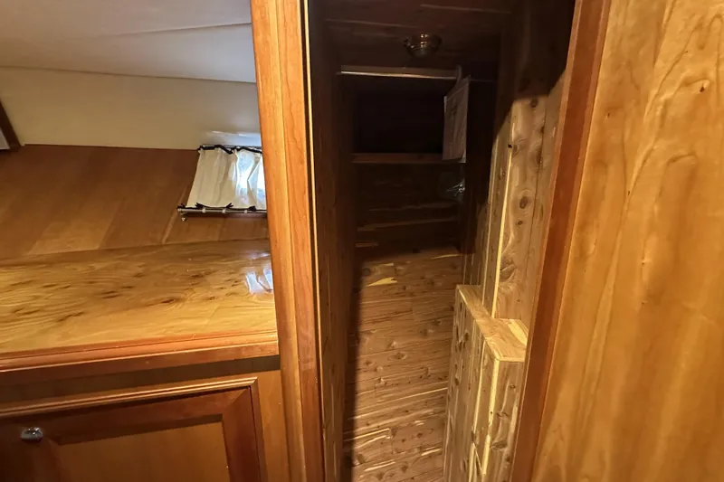 Slide: The Image of Wooden interior of 2004 McKinna 57 PHMY Widebody yacht, featuring polished surfaces and cozy design. - 89