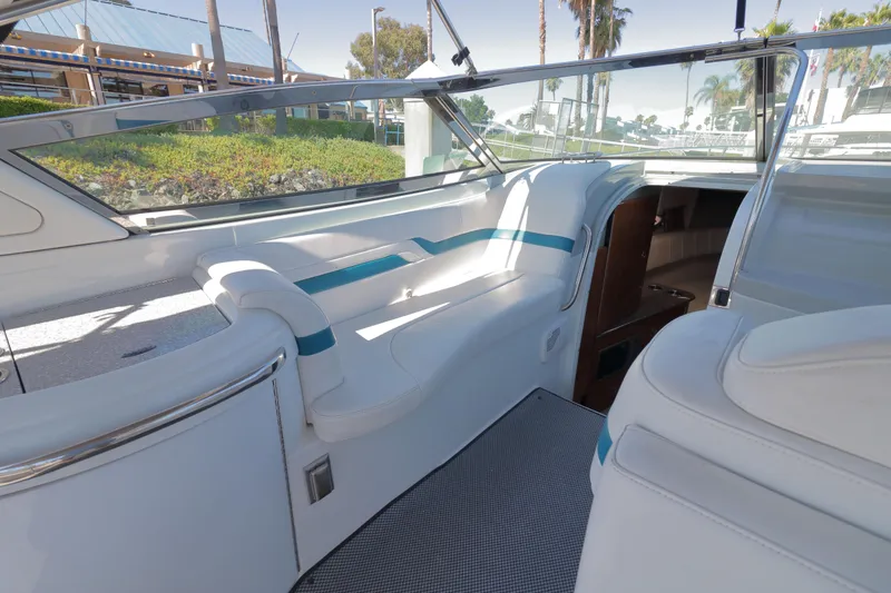 Slide: The Image of Interior of a 2006 Formula 330 Sun Sport boat with white seating and blue accents. - 12
