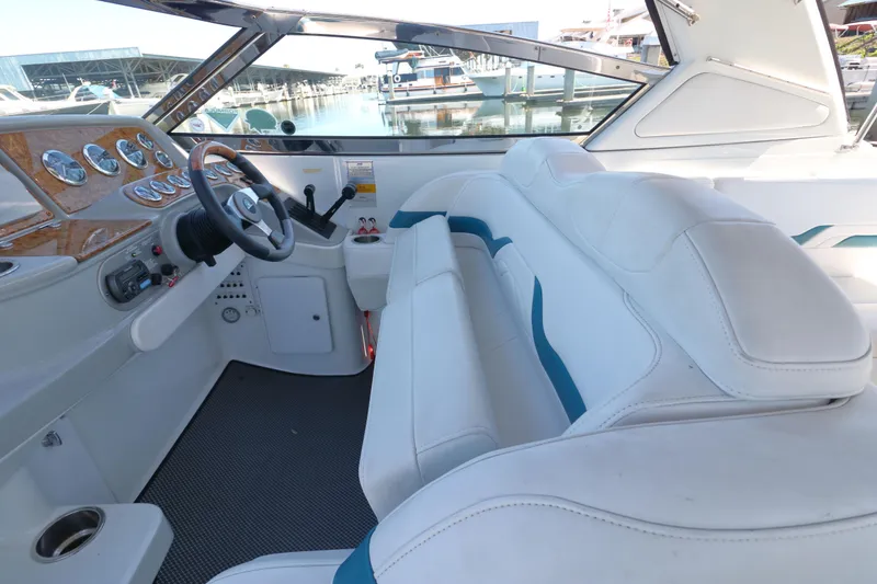 Slide: The Image of 2006 Formula 330 Sun Sport boat interior with white seating and sleek dashboard design. - 14