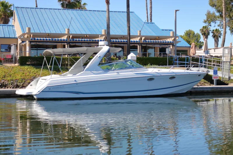 Slide: The Image of 2006 Formula 330 Sun Sport boat docked near waterfront building. - 2